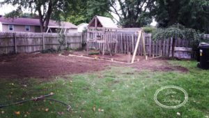 With the retaining wall in, it really started to take shape! We needed to rake the dirt smooth yet and needed to trim all the boards even with the wall….and let’s not forget the yard! My yard was well, dirt. It was fall now, and so we needed to get the rest of the yard smoothed out to put grass seed down before winter! I really didn’t want a dirt yard come spring and since our yard did slope downward, we used some of the extra dirt to level it out. The dirt we had removed was very rocky…so it made spreading it out a little difficult However, with a little hard work we managed. Within weeks the grass was starting to fill in! I was starting to feel very optimistic that it was all coming together.